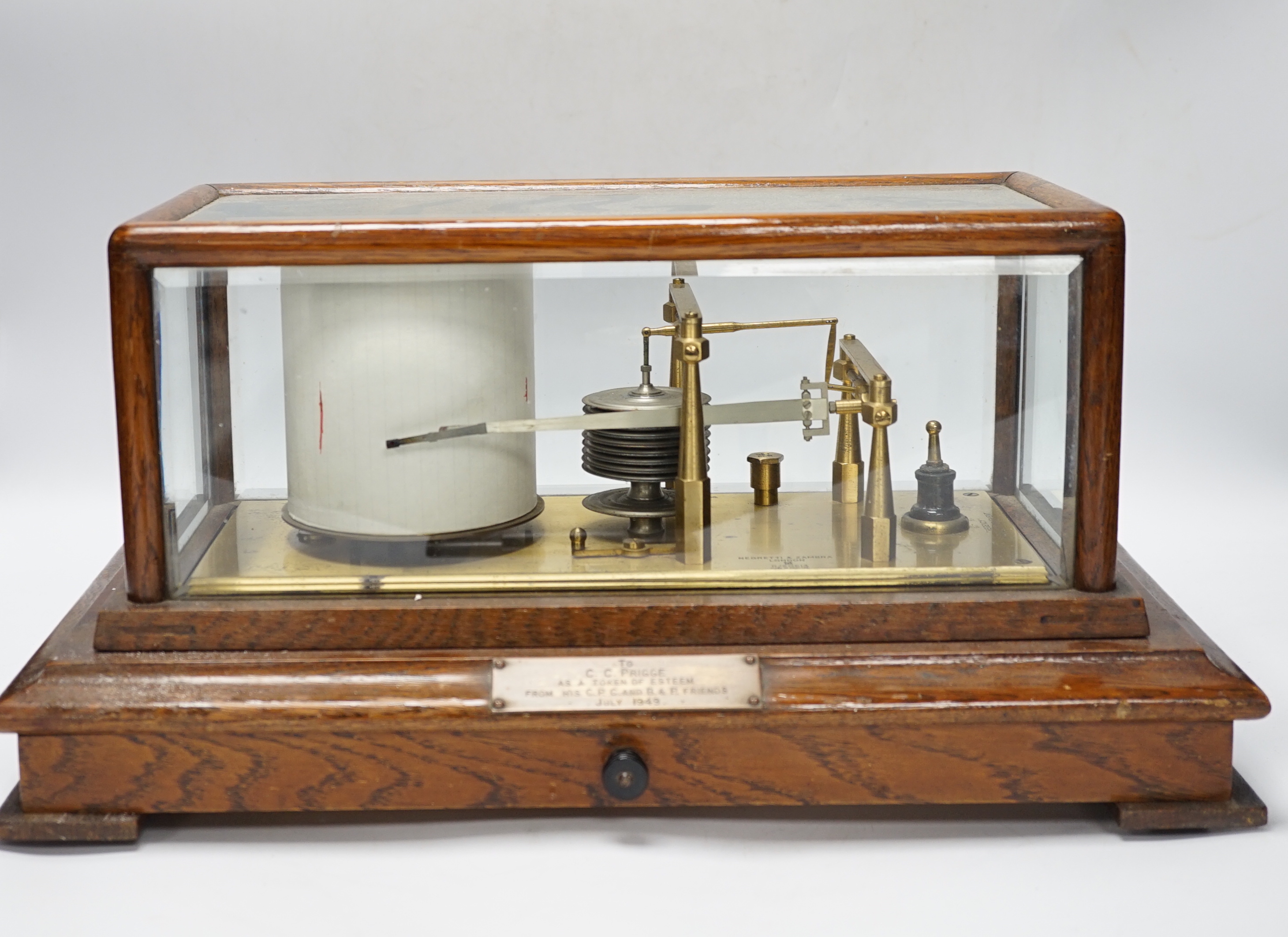A Negretti and Zambra oak-cased barograph, number R/20613 with plaque reading ‘To C.C. Prigge as a token of esteem from his C.P.C. and B&P friends, July 1949’